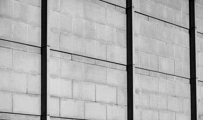 A brick wall with vertical black lines. - Photo by Strelintzki on Unsplash
