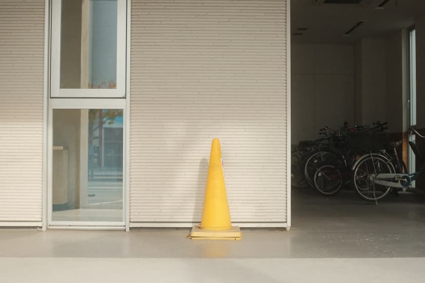 a yellow cone sitting in front of a building - Photo by Mak on Unsplash