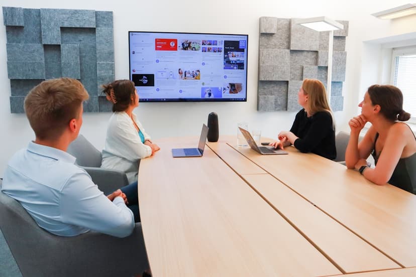 a group of people sitting around a conference table - Photo by Walls.io on Unsplash