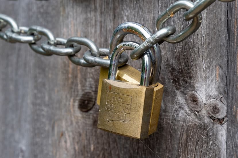 brown padlock on brown wooden fence - Photo by Georg Bommeli on Unsplash